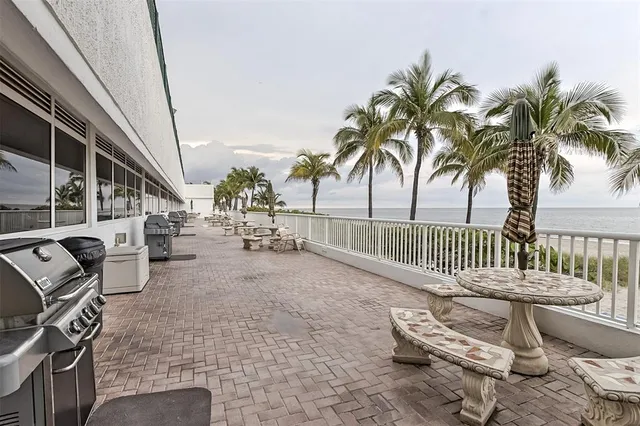 a view of a patio with a table and chairs