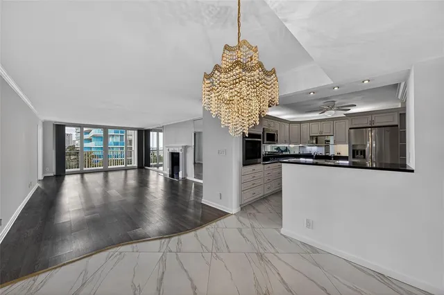 a view of a kitchen with furniture and a floor to ceiling window