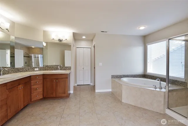 a large spacious bathroom with a large tub shower and sink