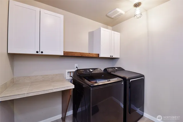 a kitchen with granite countertop cabinets and a stove top oven