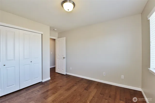 a view of an empty room and wooden floor