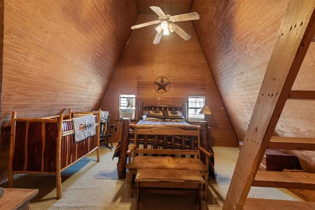 a bed room with a bed and a ceiling fan