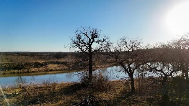 a view of a lake in middle of forest