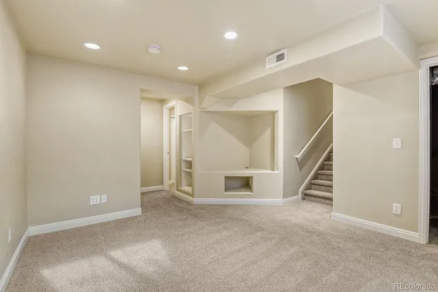 a view of an empty room with stairs