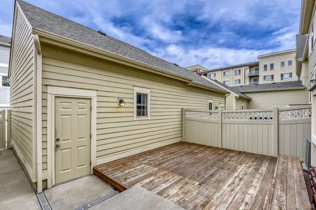 a view of a house with a wooden deck