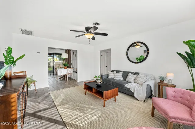 a living room with furniture a rug and a large window