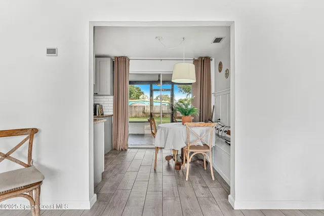 a view of a livingroom with furniture and hardwood floor