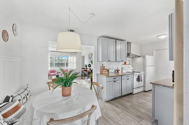 a kitchen with refrigerator and cabinets