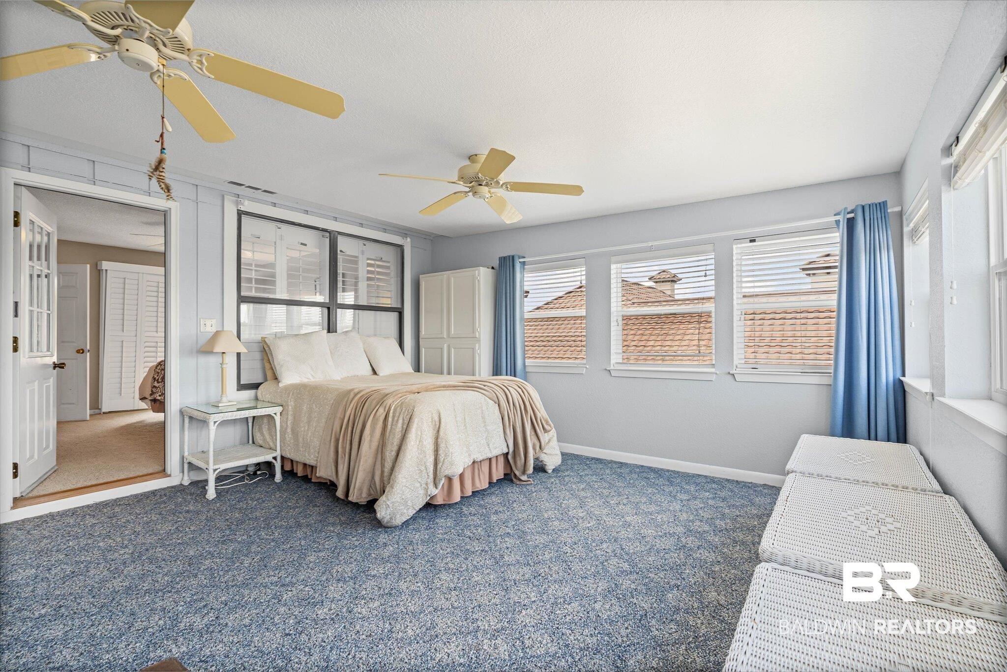 33129 River Road Orange Beach, AL 36561 - Photo 16 of 34 Carpeted bedroom with baseboards and ceiling fan