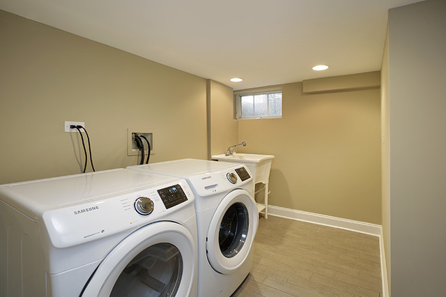 1198 Chatfield Road Winnetka, IL 60093 - Photo 22 of 25 a view of washer and dryer with kitchen in the background