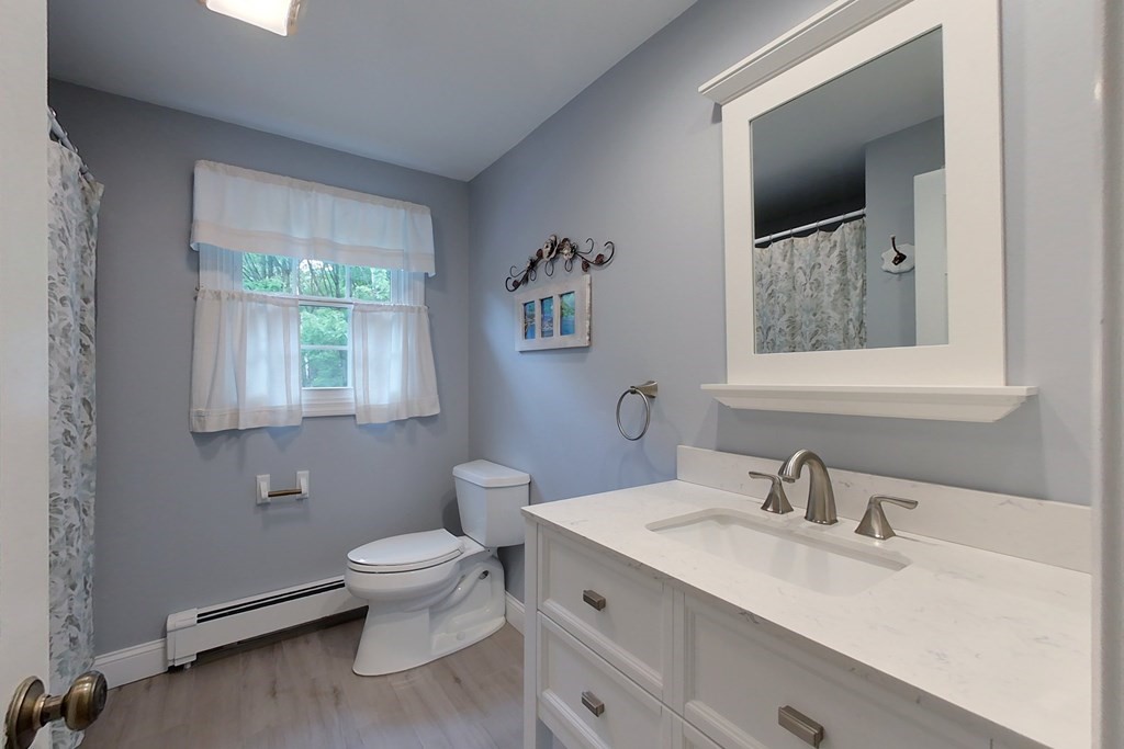 95 Clement Road Townsend, MA 01474 - Photo 33 of 42 a bathroom with a toilet sink and mirror