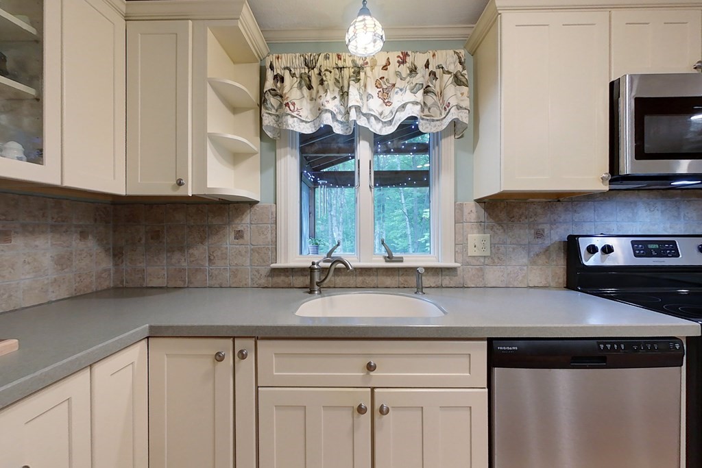 95 Clement Road Townsend, MA 01474 - Photo 4 of 42 a kitchen with stainless steel appliances granite countertop a sink dishwasher a stove and a dining table with wooden floor