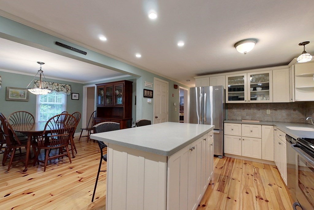 95 Clement Road Townsend, MA 01474 - Photo 6 of 42 a kitchen with stainless steel appliances kitchen island granite countertop a dining table chairs and granite counter tops