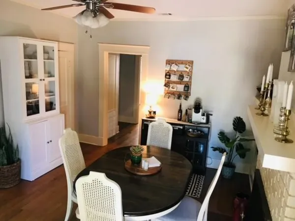 a dining room with furniture and wooden floor