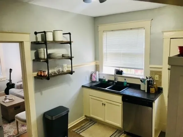 a kitchen with a sink and a stove top oven