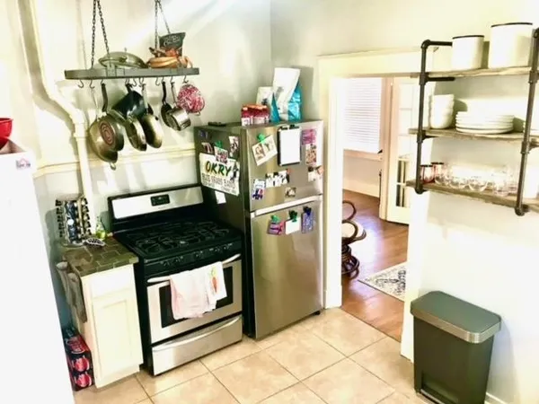 a kitchen with stainless steel appliances granite countertop a stove and a refrigerator