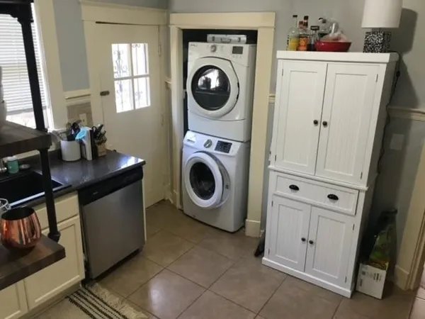a utility room with sink dryer and washer