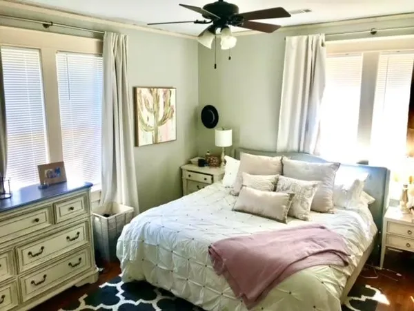 a bedroom with a bed and a window