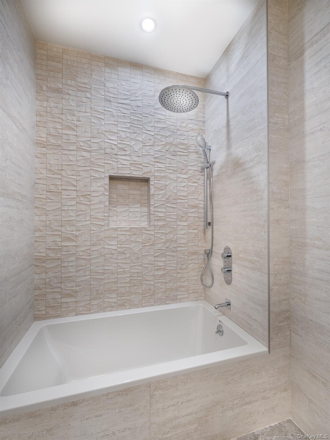 21-31 Shore Boulevard, Unit 1E Queens, NY 11105 - Photo 5 of 12 a close up of a bathtub in a bathroom