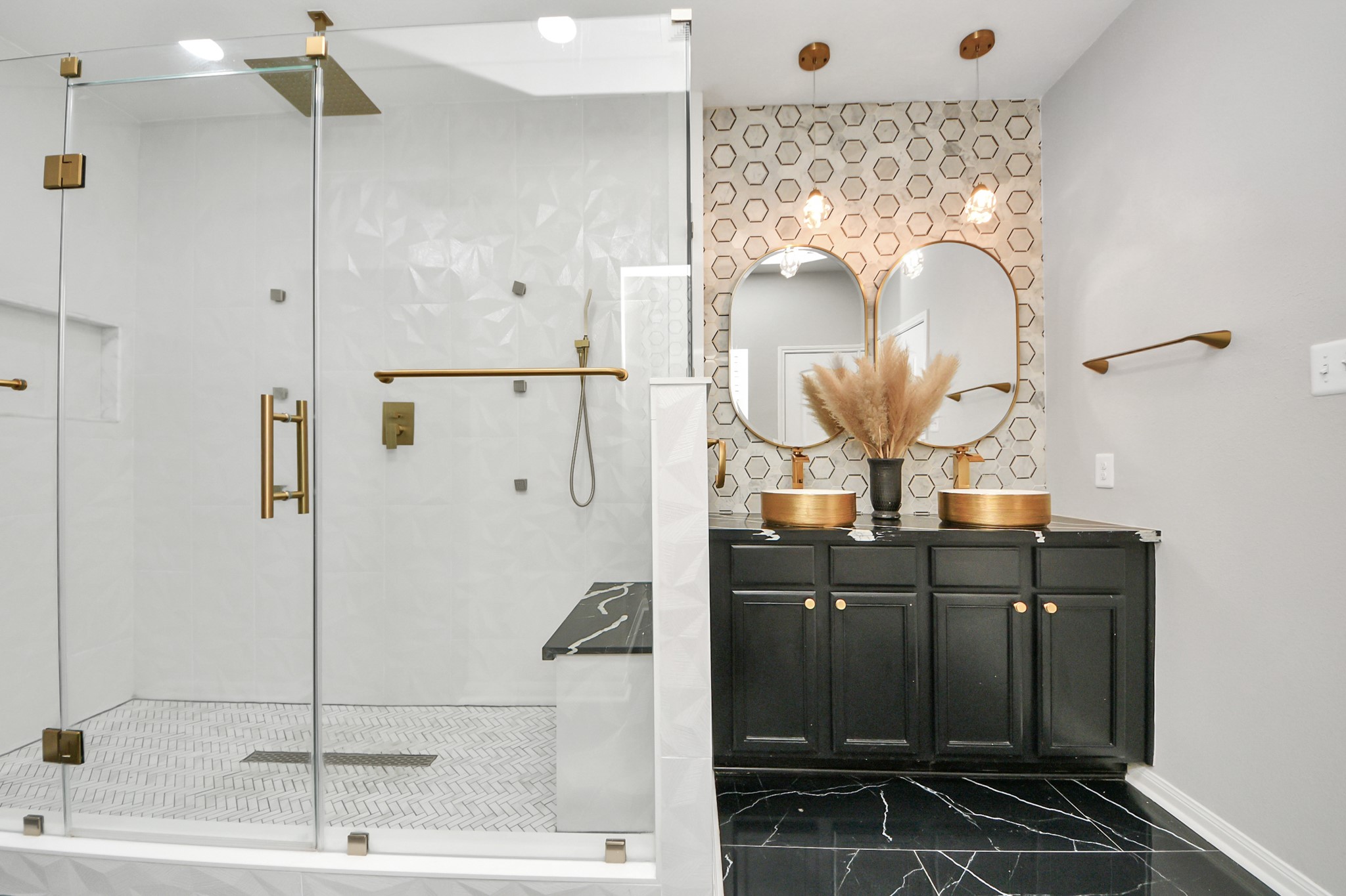 6931 Primrose Road Baytown, TX 77521 - Photo 23 of 50 Luxurious primary bath featuring a walk-in glass shower with gold fixtures, dual vanities, and designer tile accents.