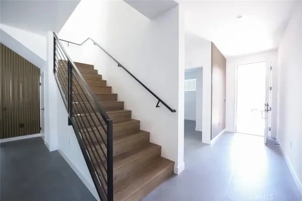 a view of hallway with wooden floor