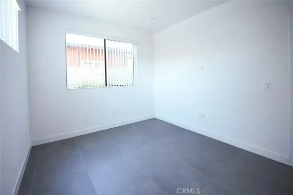a view of a room with wooden floor and window