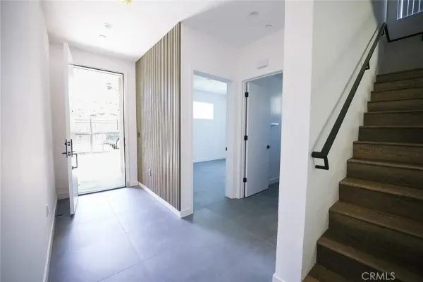 a kitchen with a sink a microwave a refrigerator and cabinets