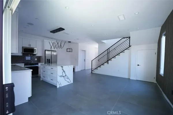 a kitchen with stainless steel appliances granite countertop a sink and a granite counter tops