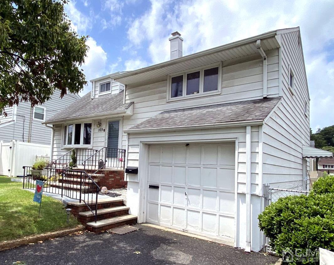 169 McFarlane Road Colonia, NJ 07067 - Photo 2 of 11 a front view of a house with a yard