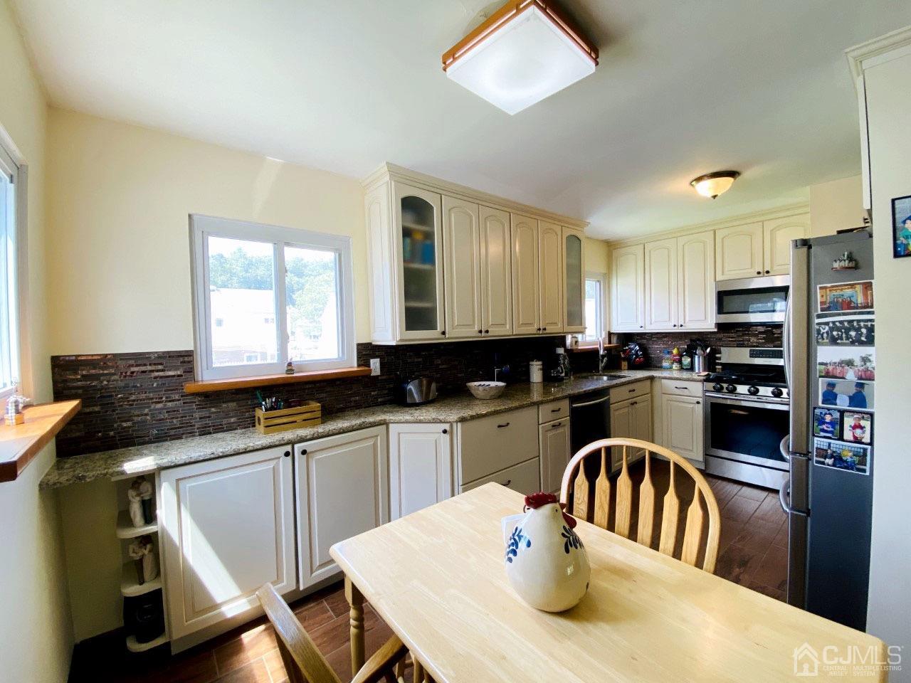 169 McFarlane Road Colonia, NJ 07067 - Photo 4 of 11 a kitchen with granite countertop a sink a counter space appliances and cabinets