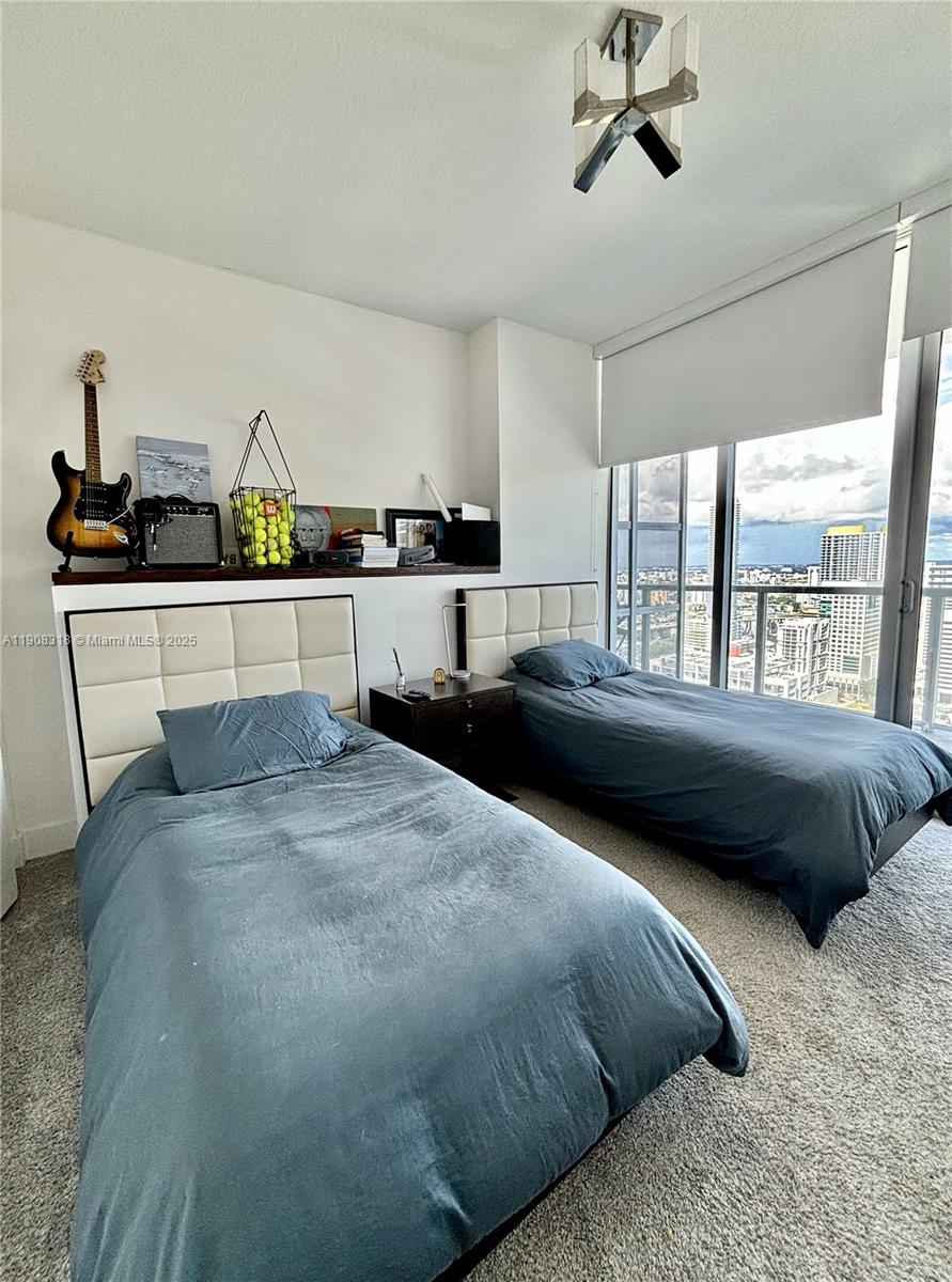 79 Southwest 12th Street, Unit 4012S Miami, FL 33130 - Photo 12 of 34 a bedroom with a bed and window