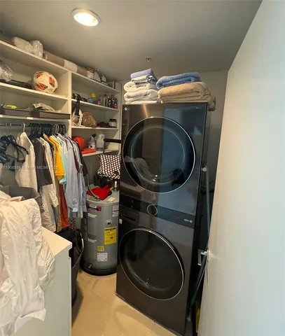 a utility room with dryer washer and other items