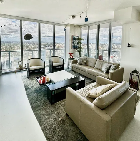 a living room with furniture and large windows