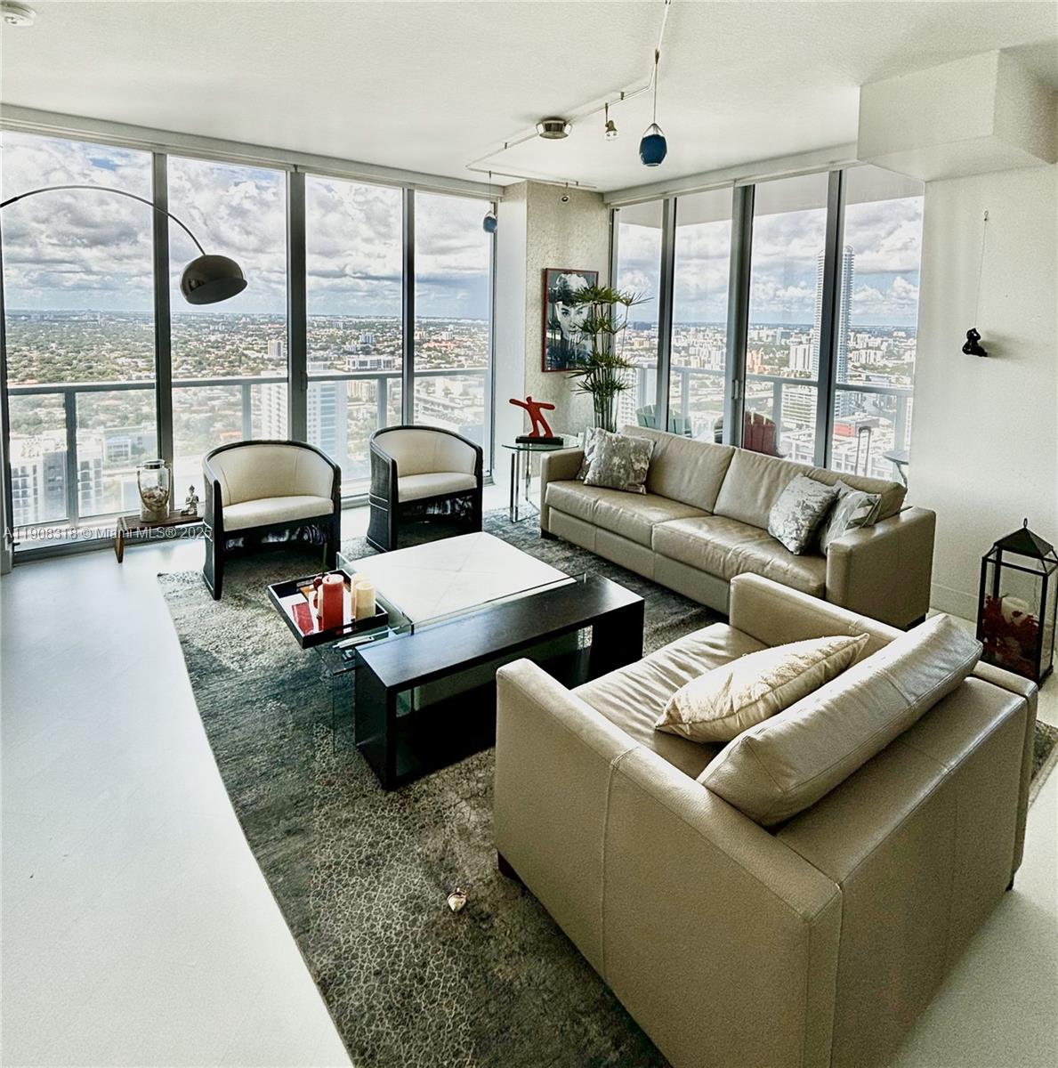 79 Southwest 12th Street, Unit 4012S Miami, FL 33130 - Photo 3 of 34 a living room with furniture and large windows