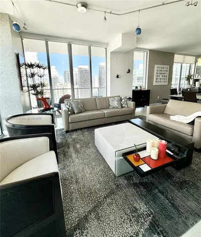 a living room with furniture a rug and a chandelier