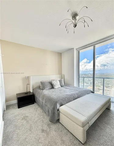 a bedroom with bed and window