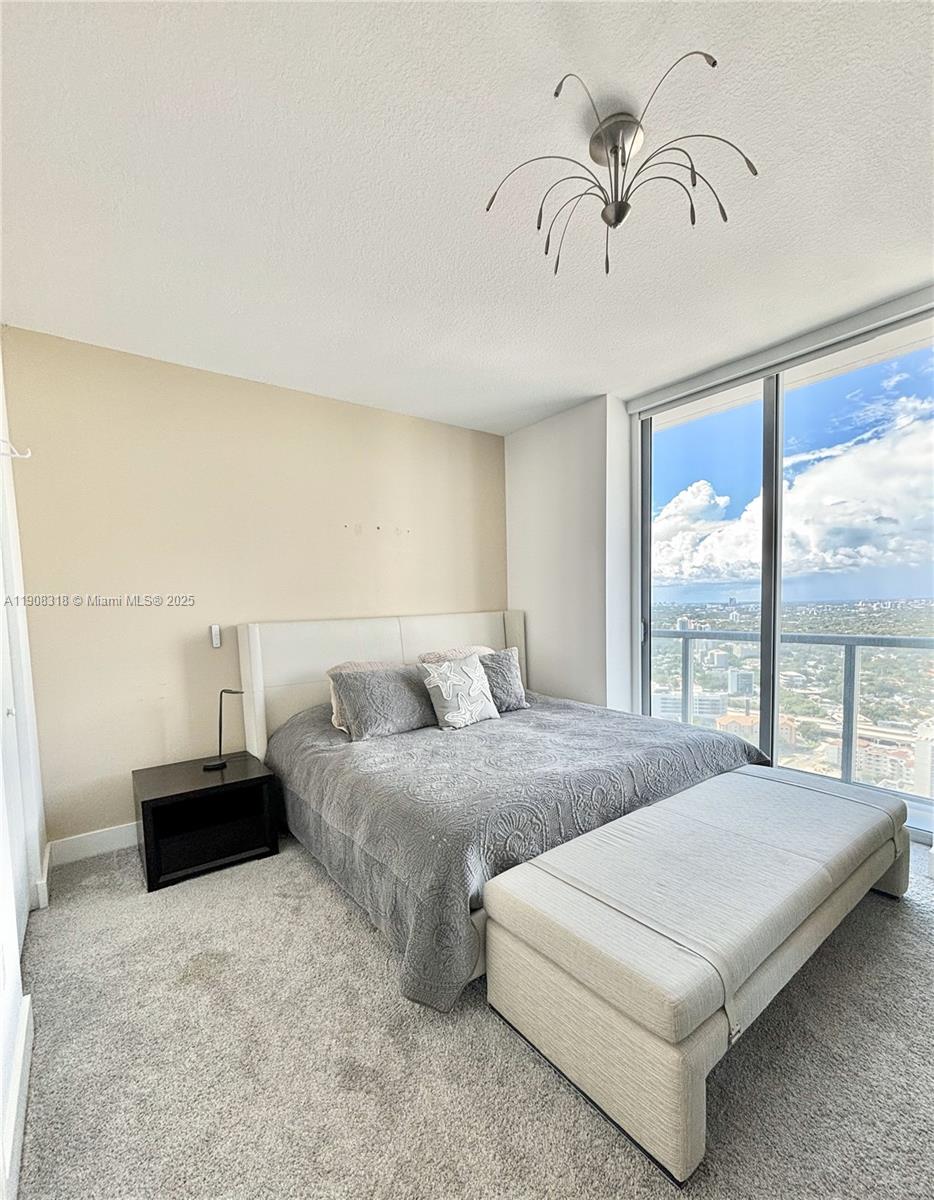 79 Southwest 12th Street, Unit 4012S Miami, FL 33130 - Photo 8 of 34 a bedroom with bed and window
