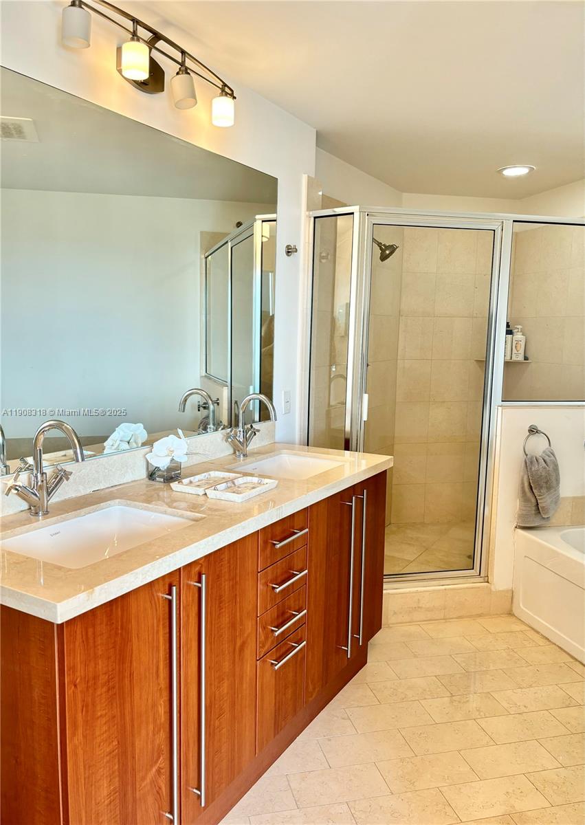 79 Southwest 12th Street, Unit 4012S Miami, FL 33130 - Photo 9 of 34 a bathroom with a sink double vanity and a mirror
