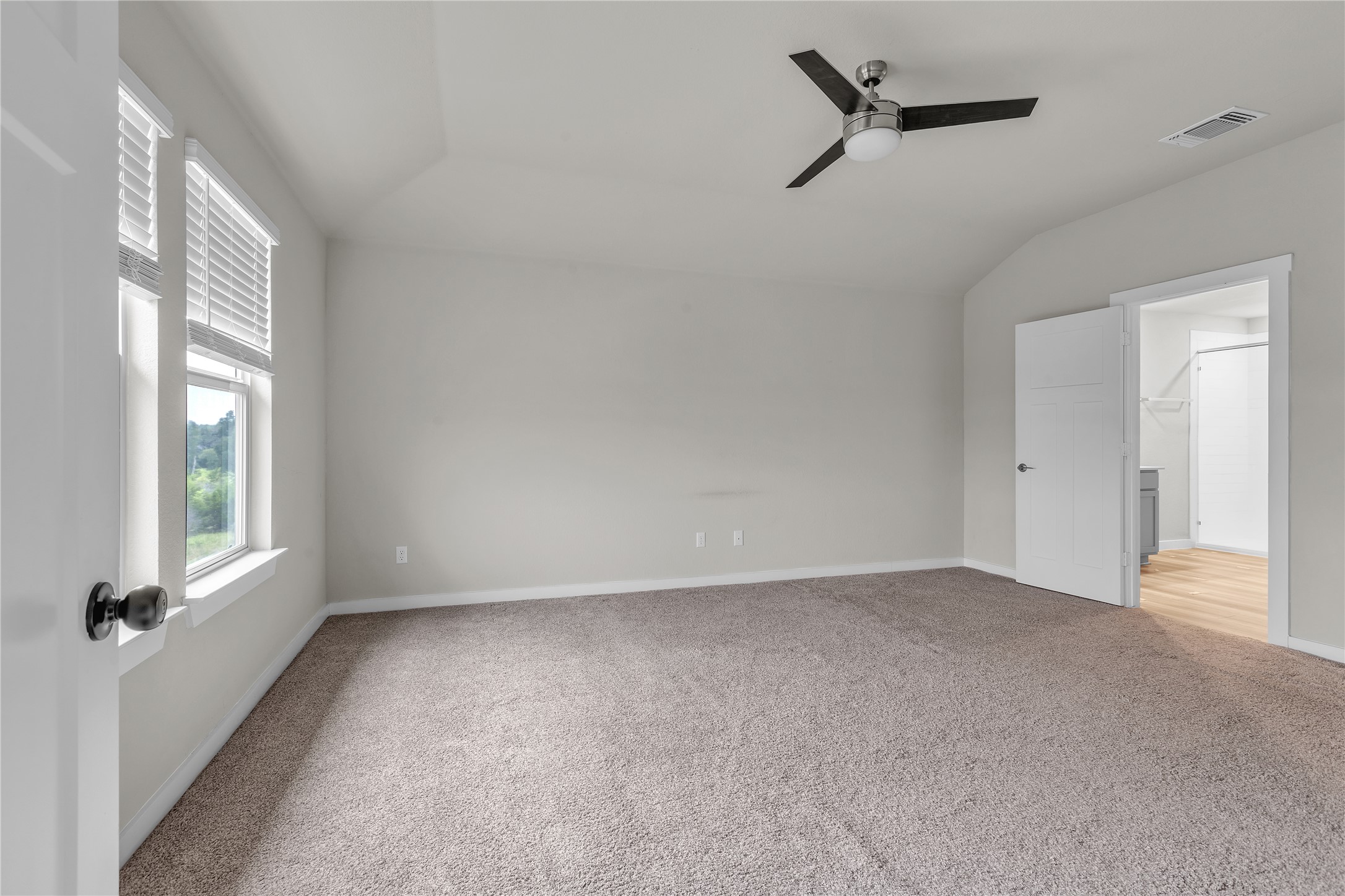 1212 Tipton Street Georgetown, TX 78633 - Photo 17 of 20 An airy primary bedroom awaits, offering plush carpet flooring and a ceiling fan for comfort.