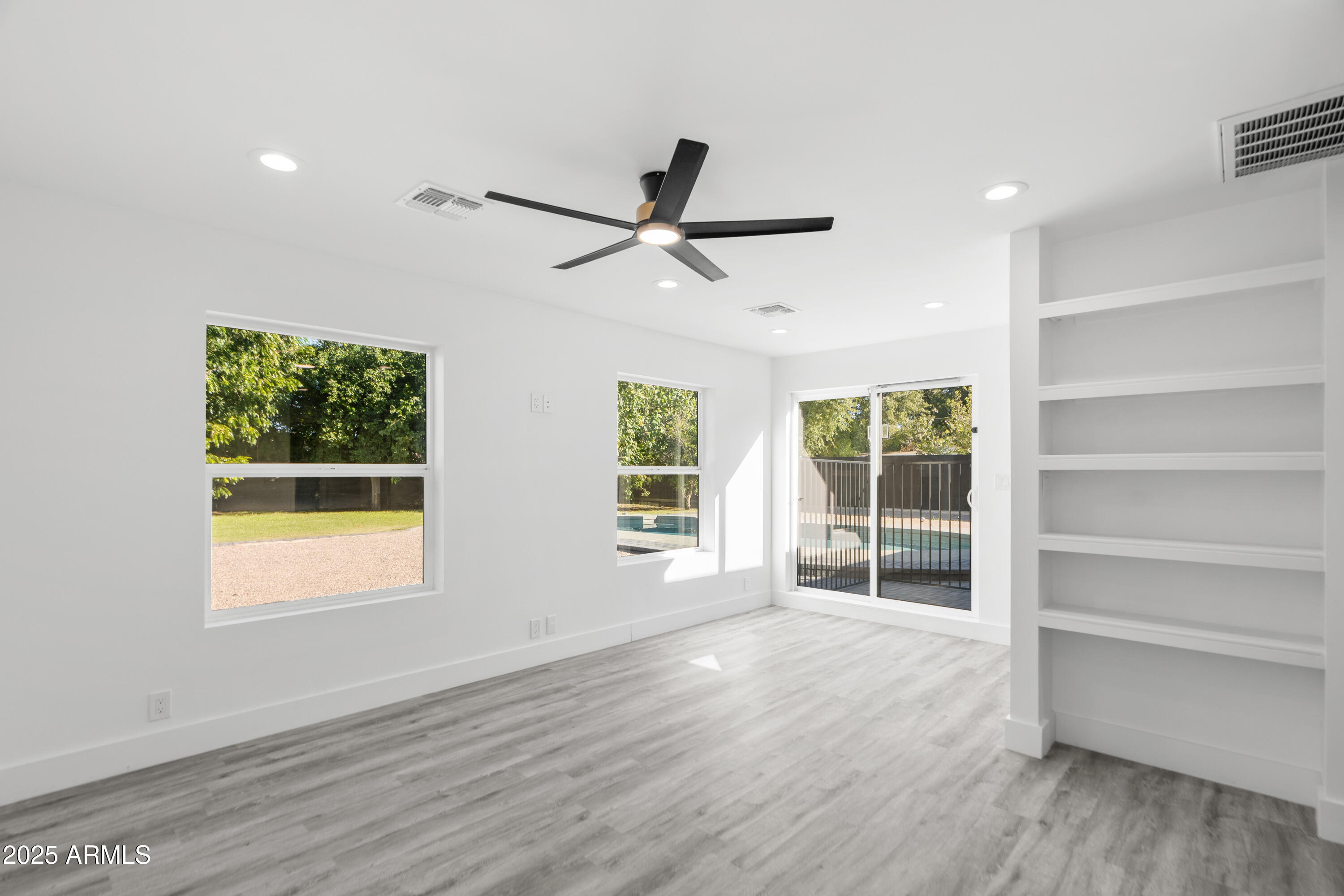 2502 East Whitton Avenue Phoenix, AZ 85016 - Photo 11 of 34 a view of an empty room with a window and wooden floor