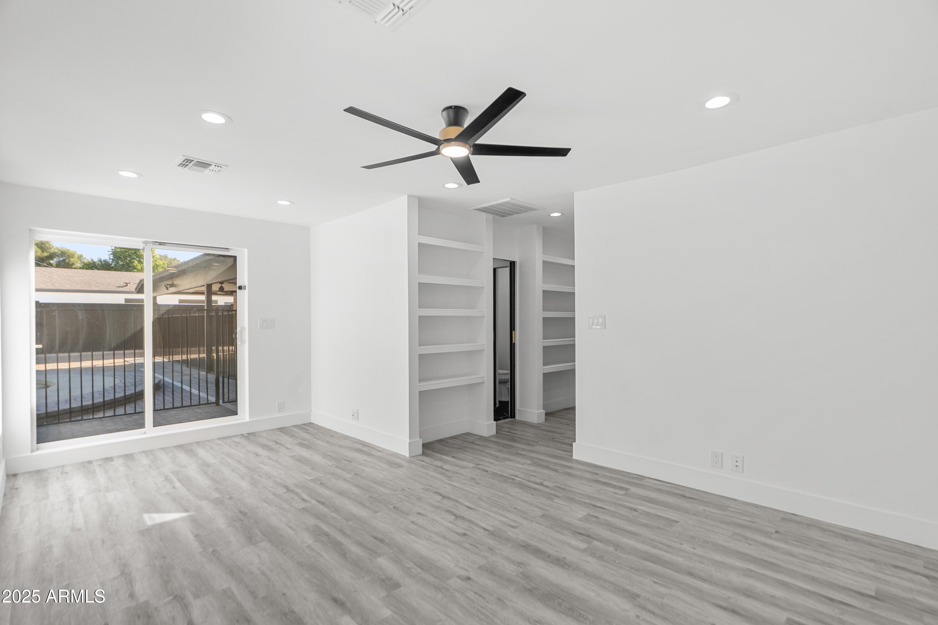 2502 East Whitton Avenue Phoenix, AZ 85016 - Photo 12 of 34 an empty room with wooden floor and windows
