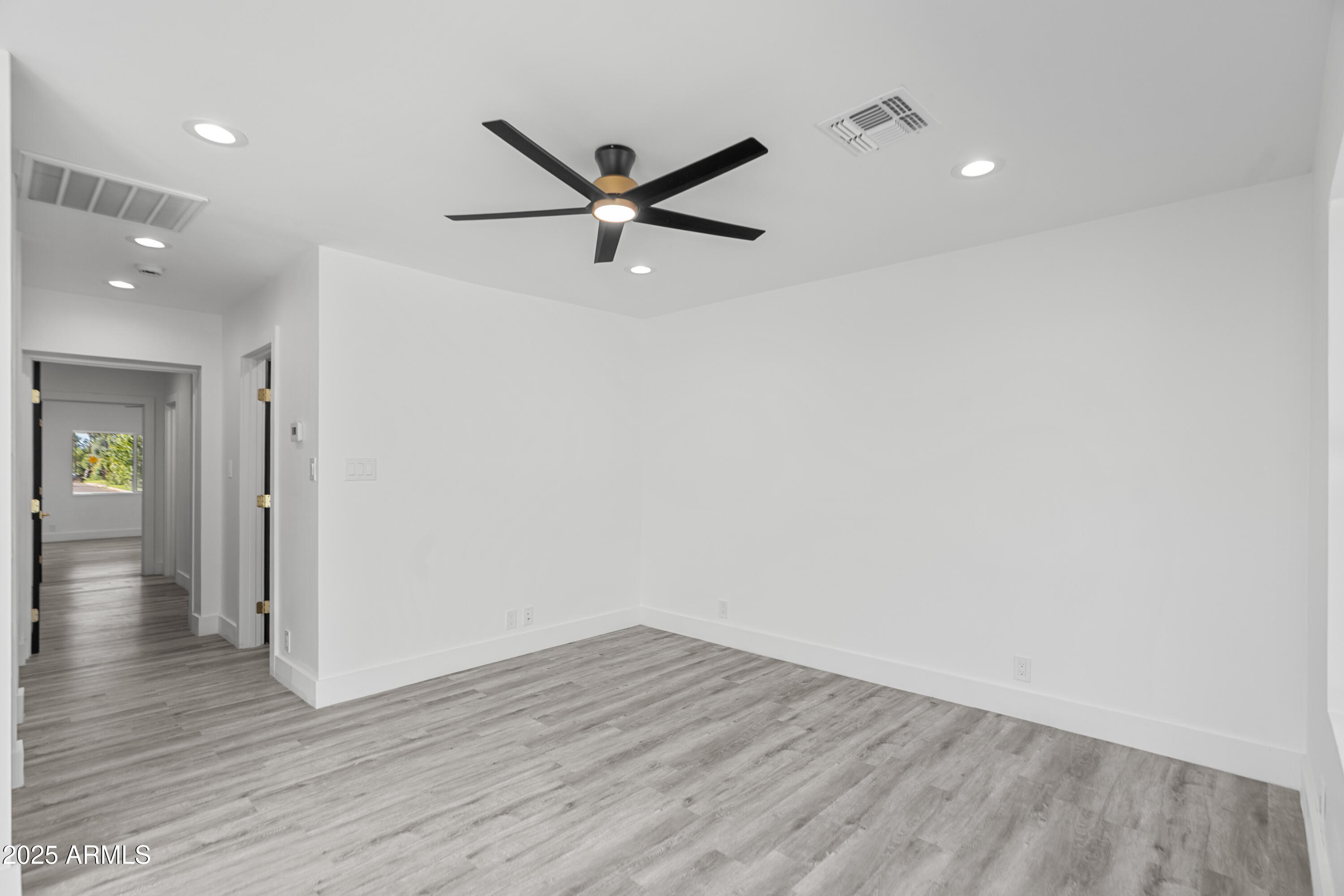 2502 East Whitton Avenue Phoenix, AZ 85016 - Photo 13 of 34 a view of a livingroom with wooden floor and a ceiling fan