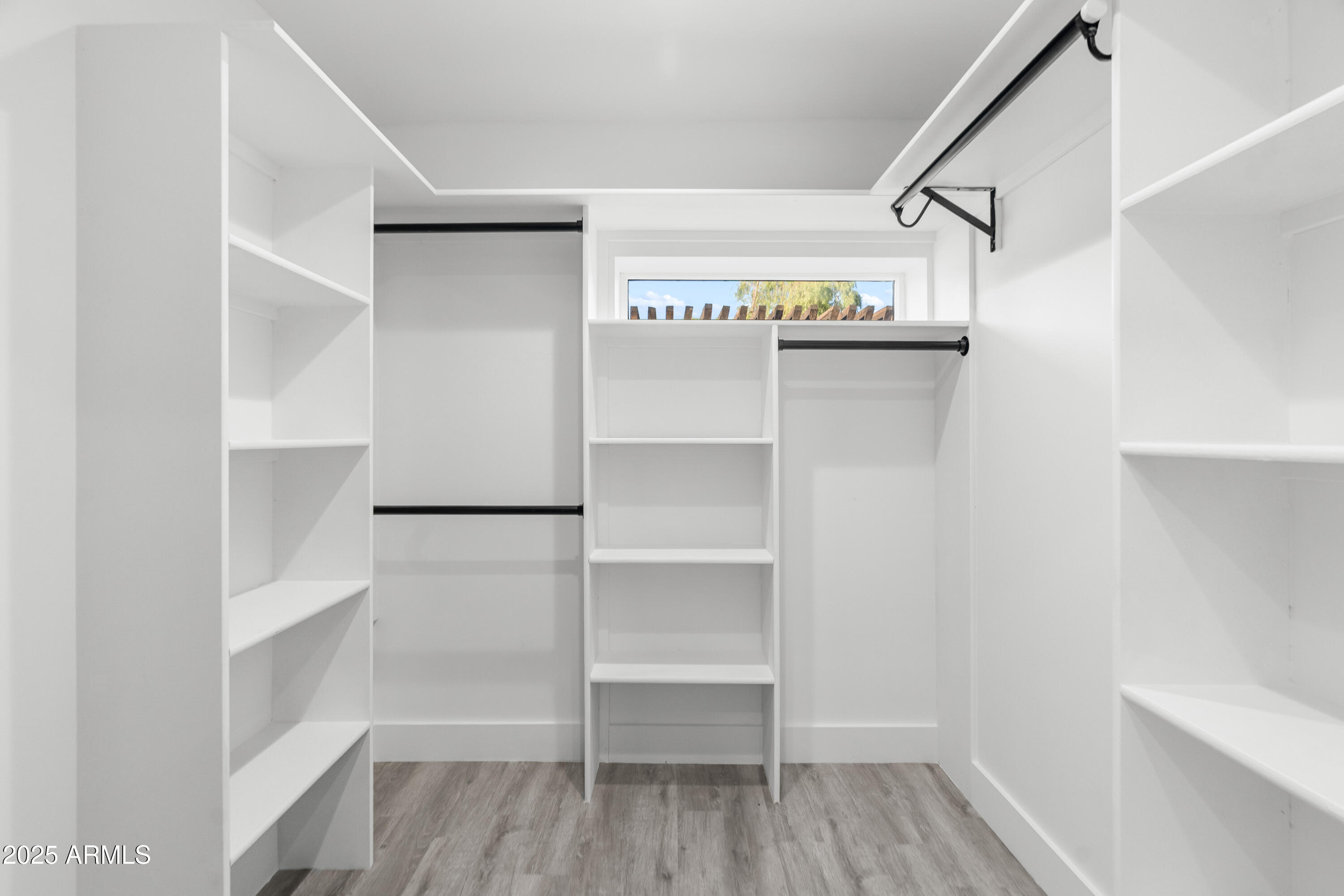 2502 East Whitton Avenue Phoenix, AZ 85016 - Photo 17 of 34 a view of walk in closet with empty racks
