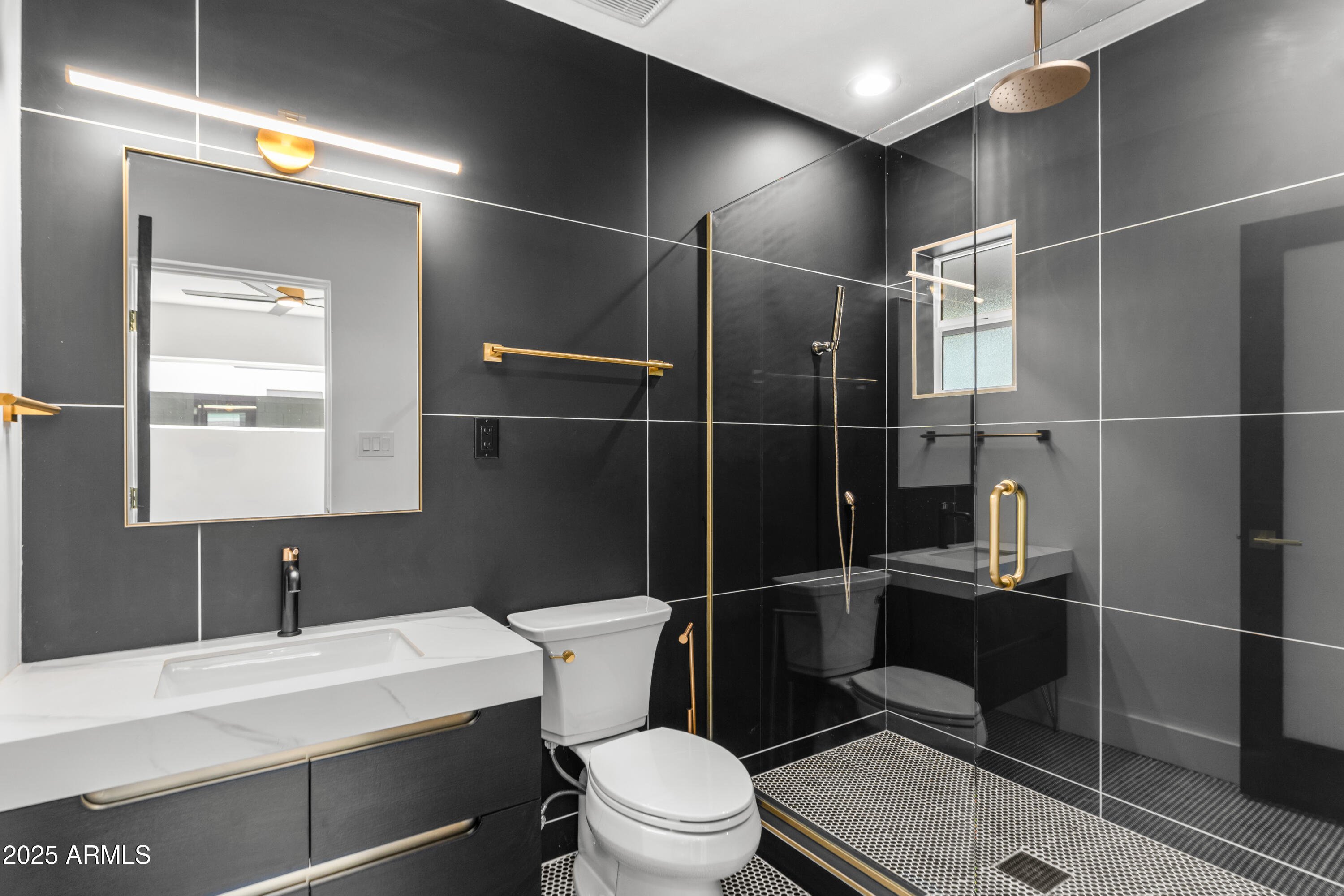 2502 East Whitton Avenue Phoenix, AZ 85016 - Photo 24 of 34 a bathroom with a sink a toilet a mirror and shower