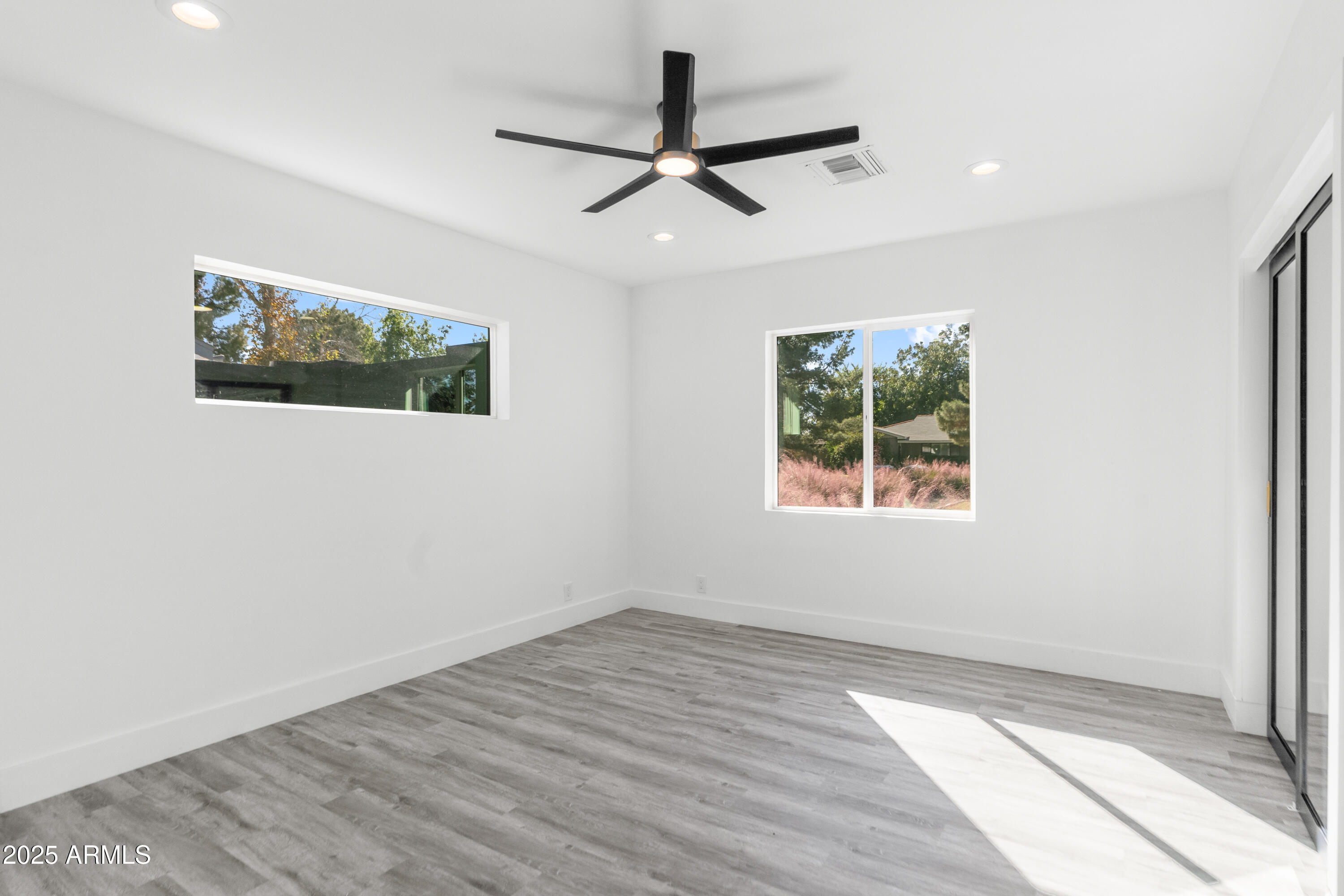 2502 East Whitton Avenue Phoenix, AZ 85016 - Photo 25 of 34 a view of an empty room with wooden floor and a window