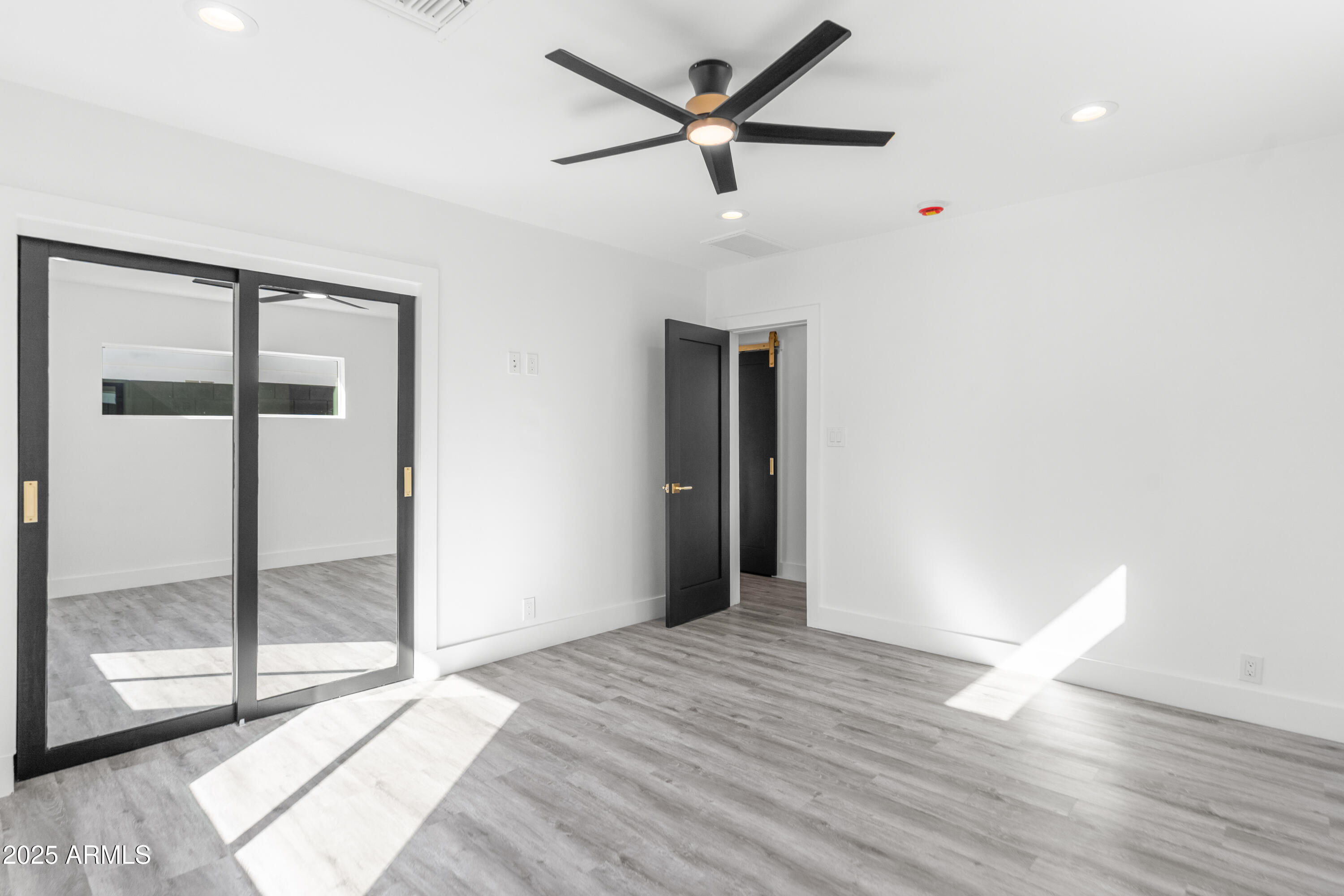 2502 East Whitton Avenue Phoenix, AZ 85016 - Photo 26 of 34 a view of empty room with wooden floor and fan
