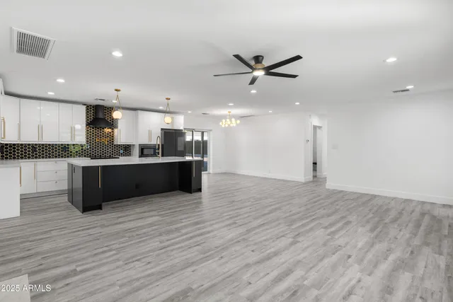 a view of kitchen with microwave and cabinets
