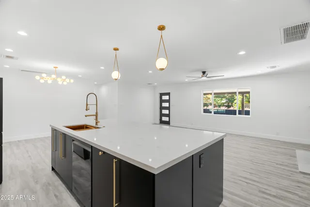 a kitchen with a sink appliances and cabinets