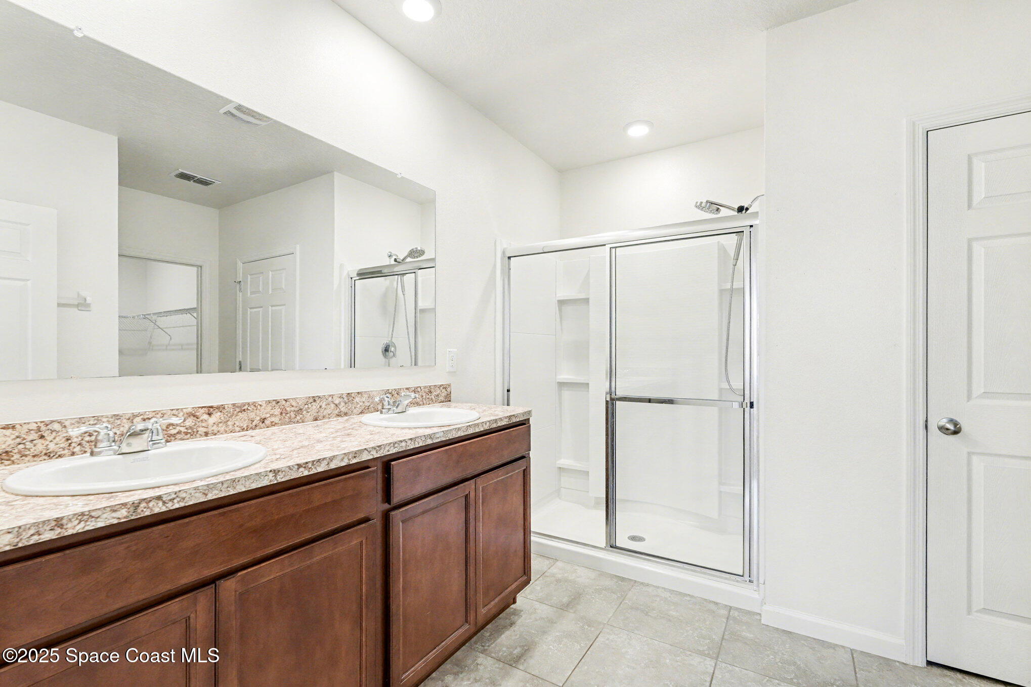 4604 Magenta Isles Drive Melbourne, FL 32904 - Photo 16 of 17 a view of bathroom with a sink a mirror and a shower