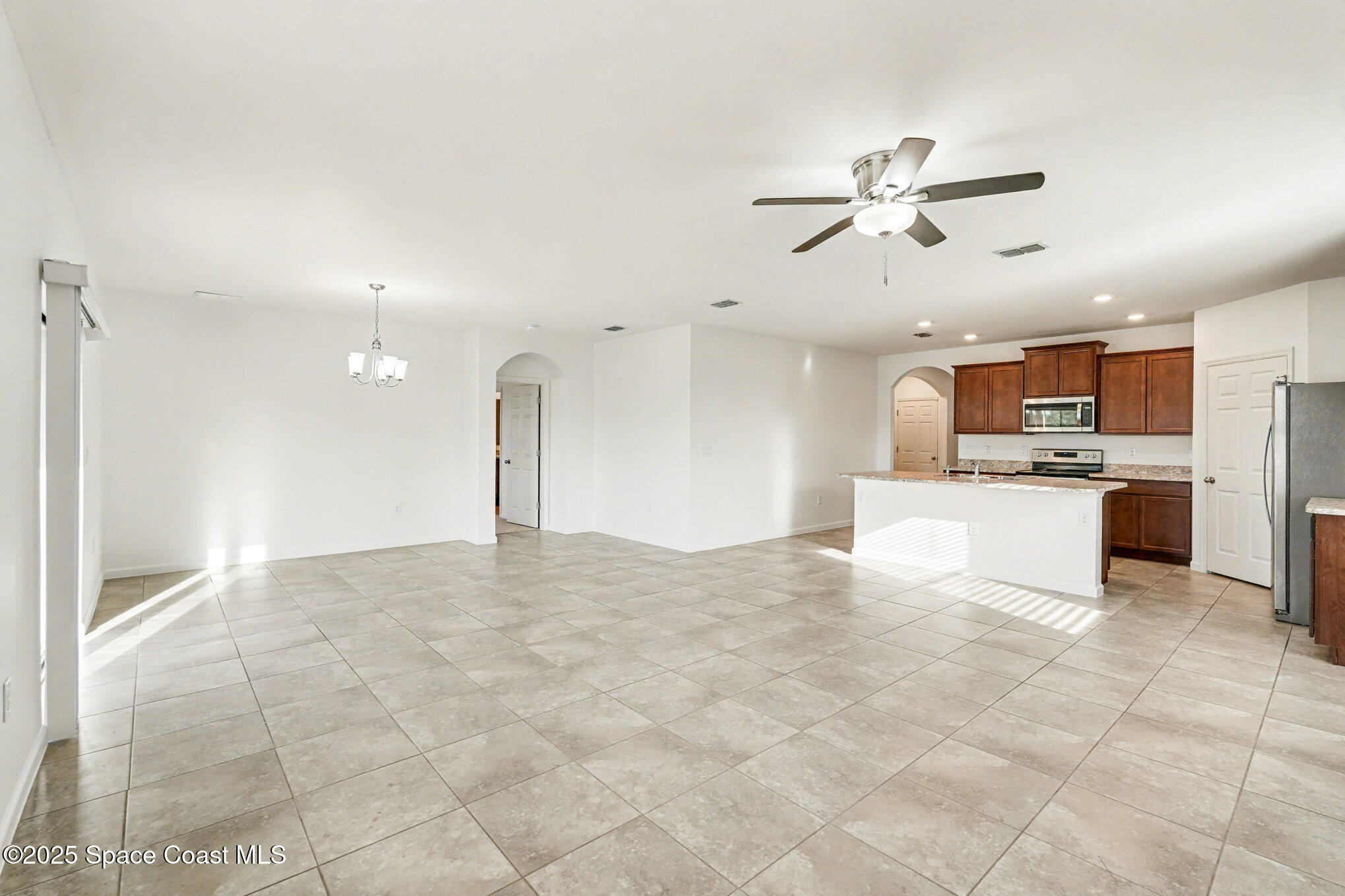 4604 Magenta Isles Drive Melbourne, FL 32904 - Photo 6 of 17 a view of a kitchen with a sink and a refrigerator